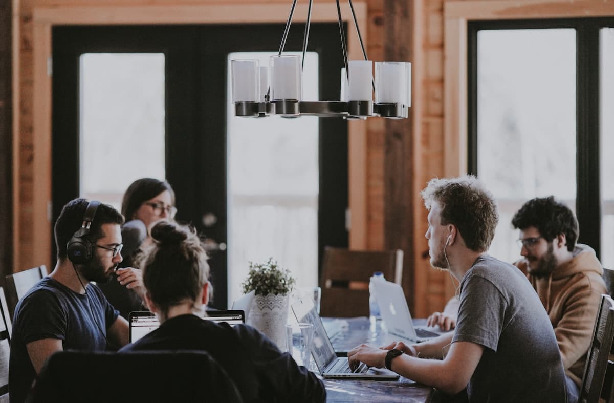 A small business team working together around a table with laptops