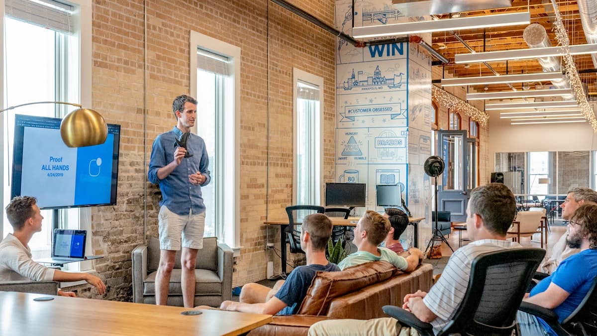 A small team meeting in an office, one person presenting to the group
